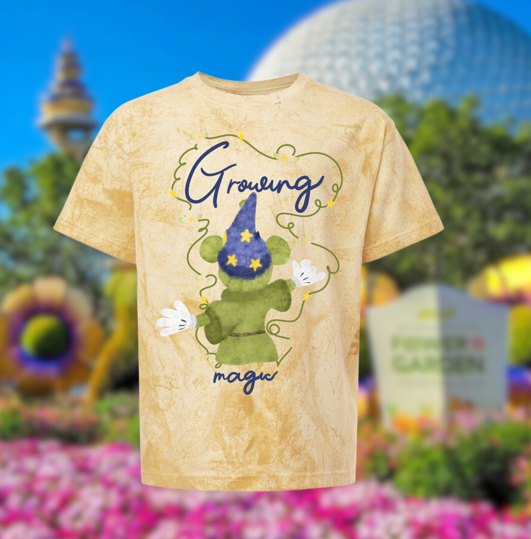 Disney-inspired t-shirt with sorcerer mouse topiary and 'Growing magic' text at theme park garden