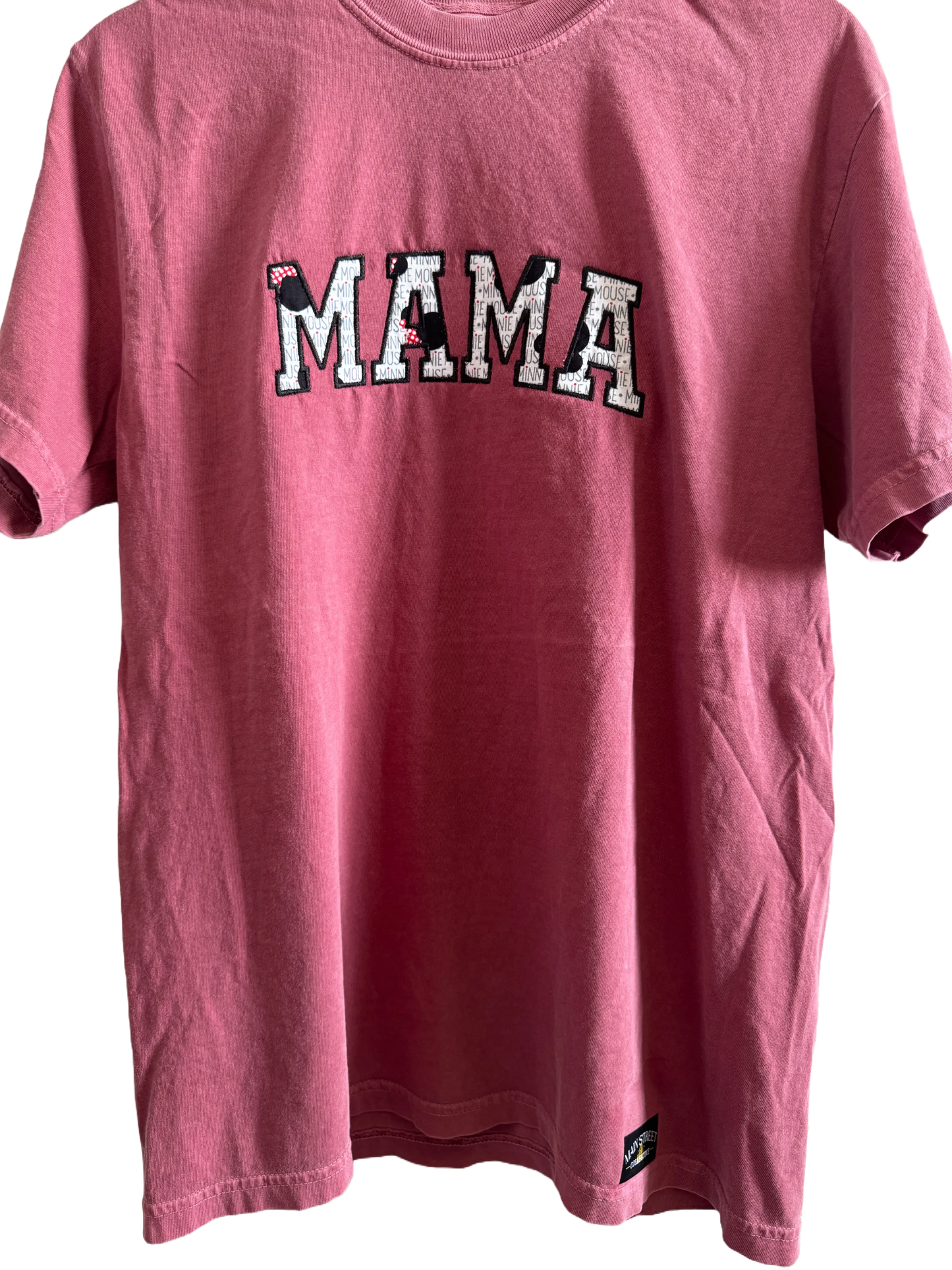 Pink embroidered MAMA tee with mouse ear bow details and playful Disney-inspired lettering