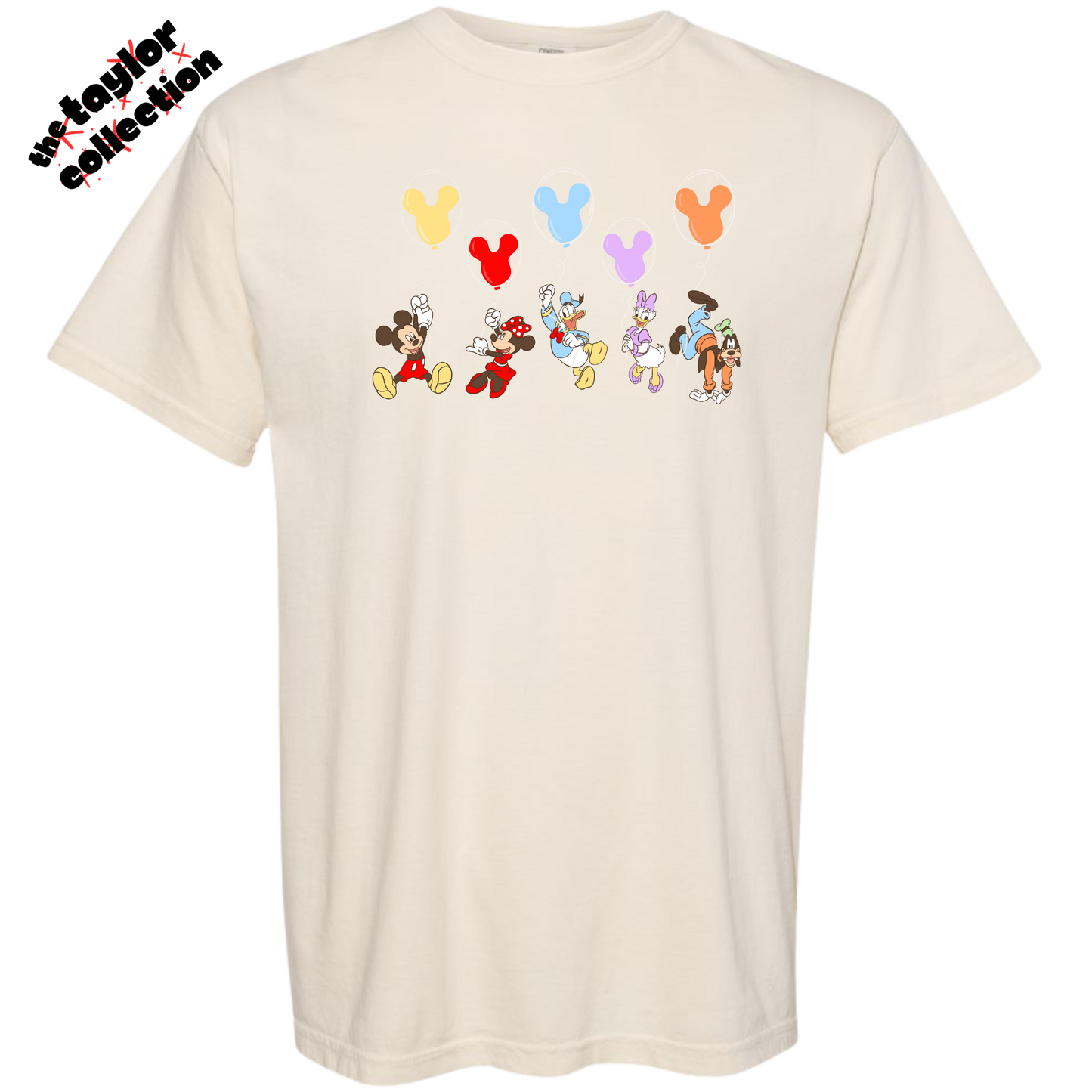 Beige t-shirt with cartoon character designs and balloons on a white background