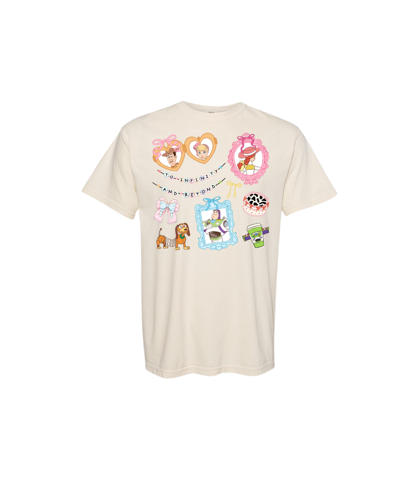 Cream t-shirt with colorful cartoon character frames, theme park treats, and 'To Infinity and Beyond' text