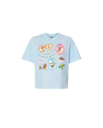 Light blue t-shirt with colorful graphics on a white background
