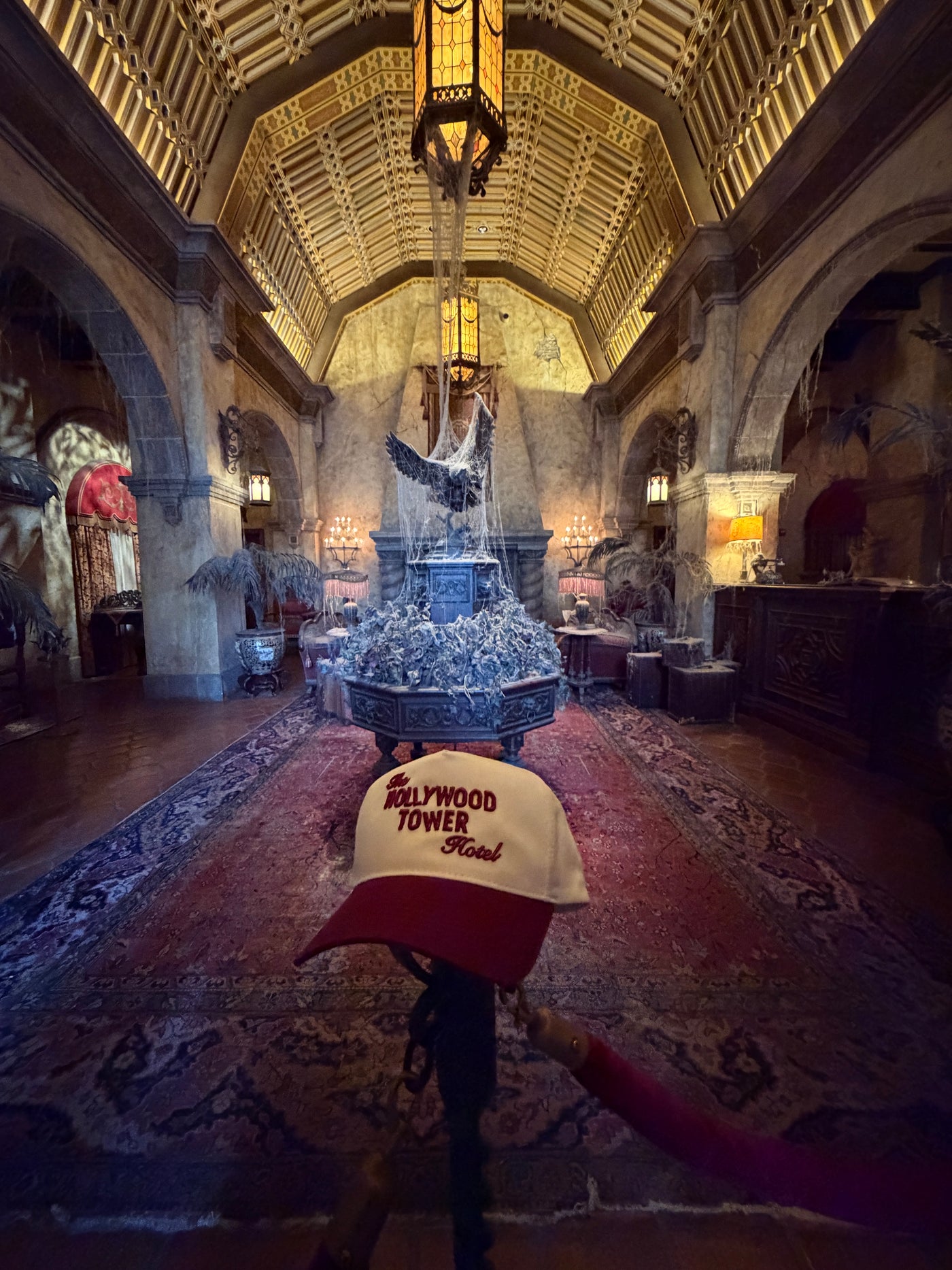 Hollywood Tower Hotel cap in vintage hotel lobby with ornate decor and cobwebs