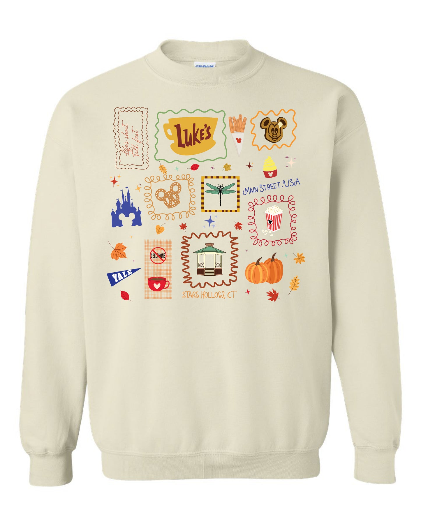 Sand crewneck sweatshirt with colorful fall and Main Street USA themed icons and graphics on front.