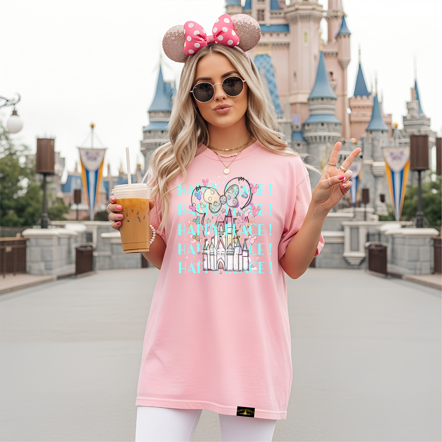 Woman in pink shirt with Disney castle and mouse ears design