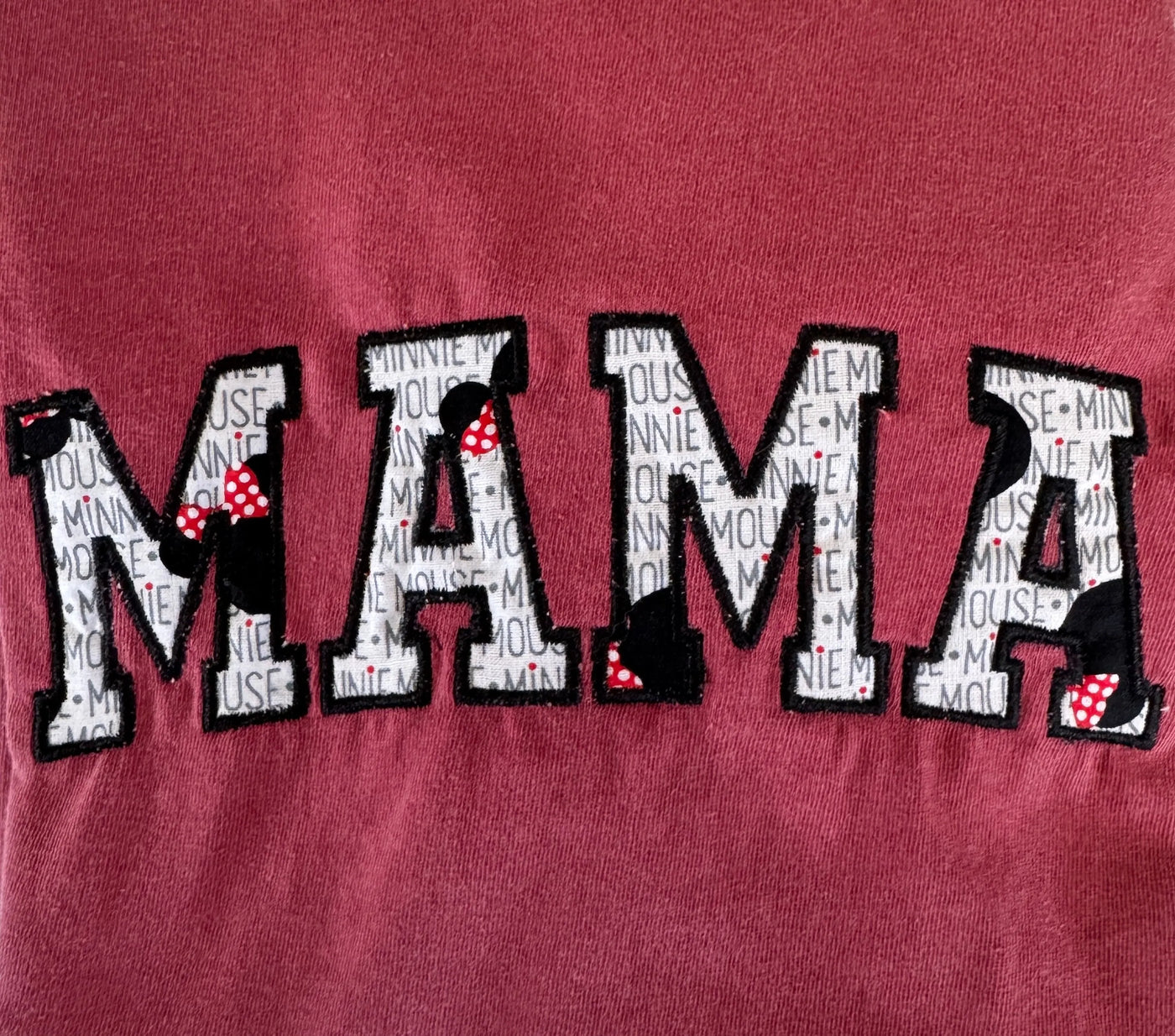 Embroidered MAMA tee with Minnie-inspired letters and polka dot bows on maroon fabric
