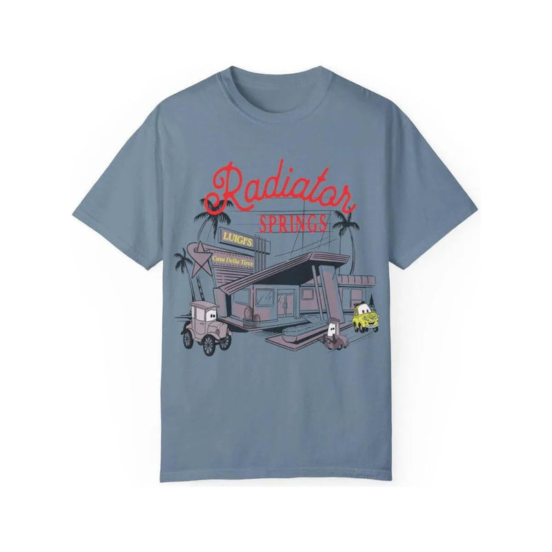 Blue t-shirt featuring a Radiator Springs Luigi's Casa Della Tires graphic with cartoon cars.