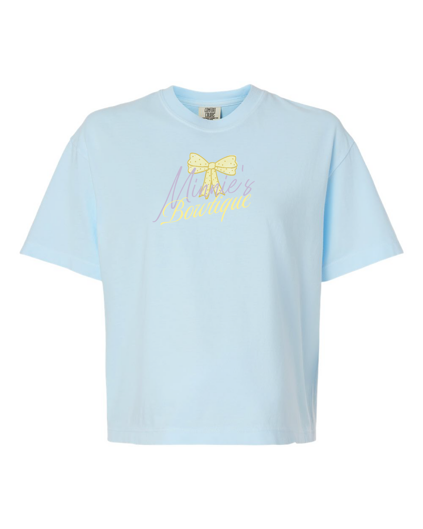 Light blue cropped t-shirt with yellow bow and 'Minnie's Bowtique' graphic on front.