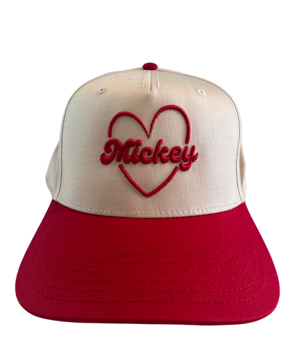 Cream and red snapback hat with embroidered red heart and Mickey text on front