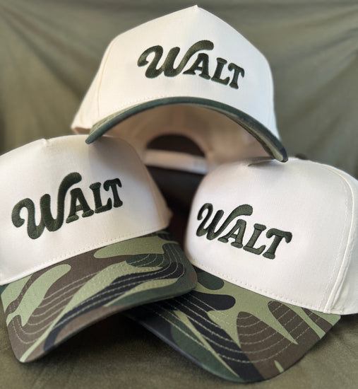 Three caps with 'WALT' branding on a green background
