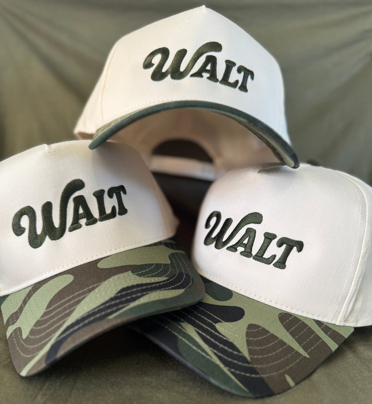 Three caps with 'WALT' branding on a green background