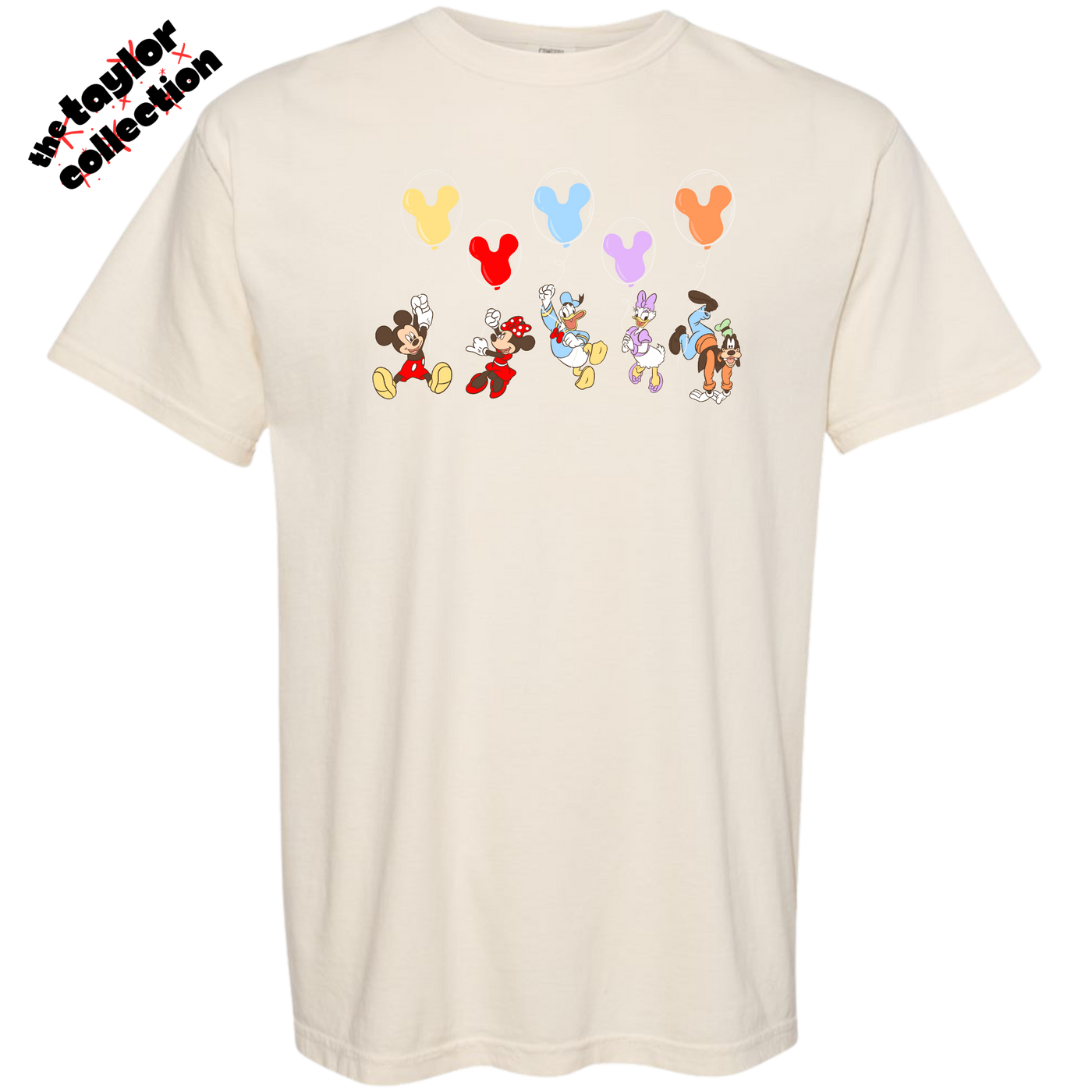 Beige t-shirt with cartoon character designs and balloons on a white background