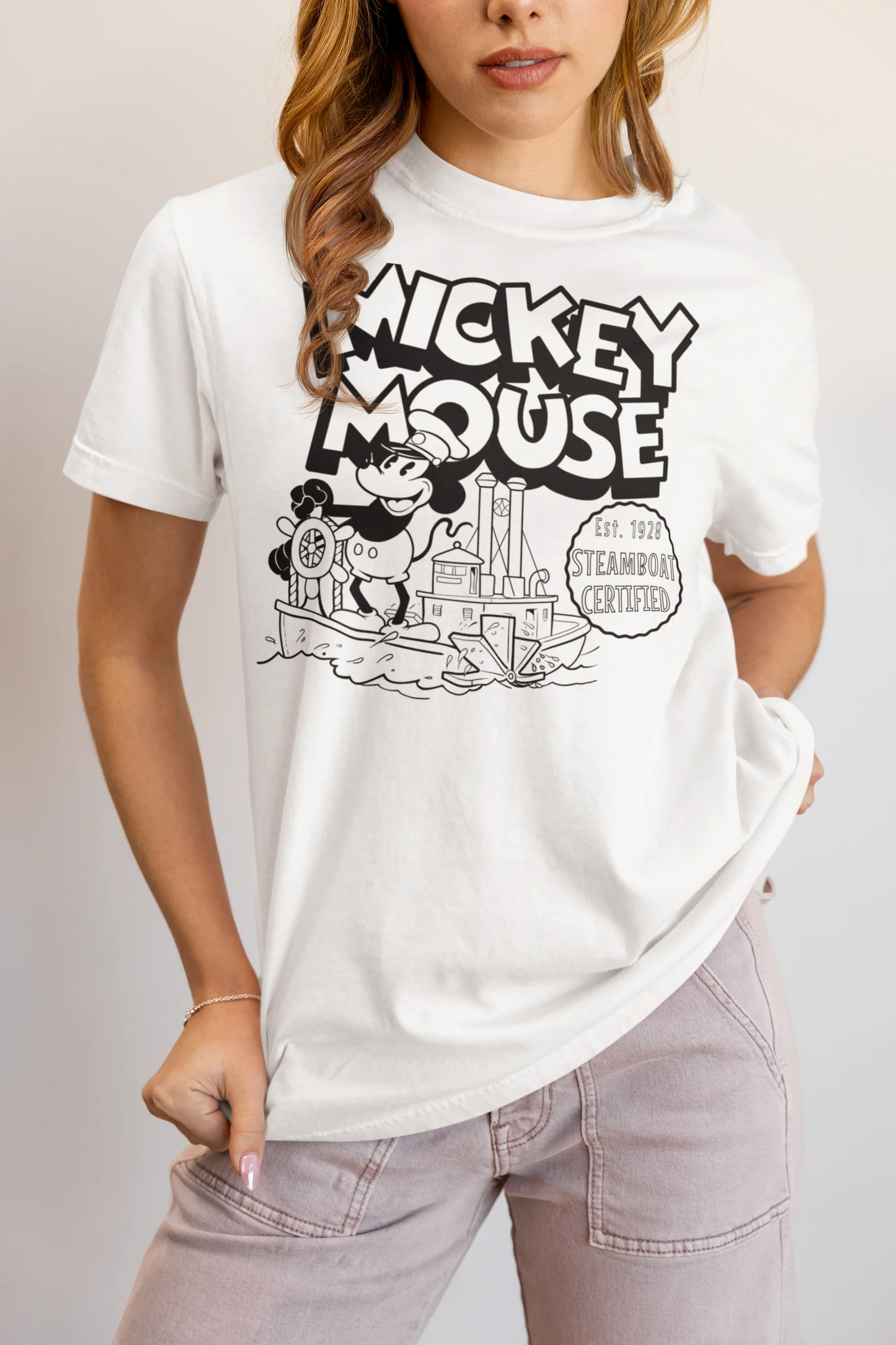 Woman wearing a white vintage Steamboat Mickey Mouse graphic t-shirt with black print.