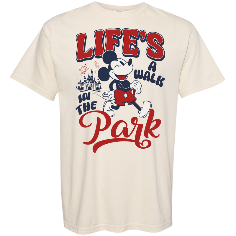 Cream t-shirt with cartoon mouse, castle, fireworks, and 'Life's a walk in the park' graphic.